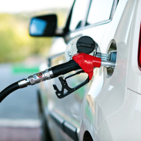 Gas station pump filling up a car.