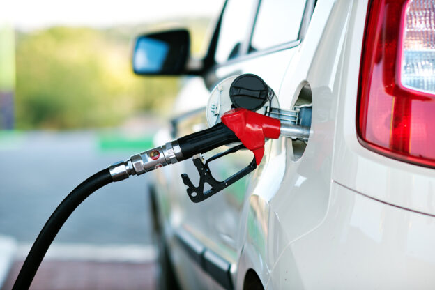 Gas station pump filling up a car.