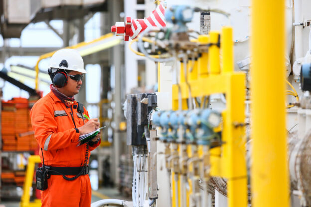 Oil & Gas Worker Checking Pipes