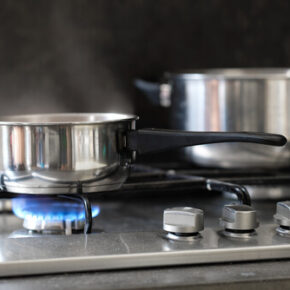 Person Cooking Over a Gas Stove