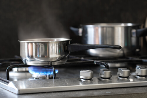 Person Cooking Over a Gas Stove